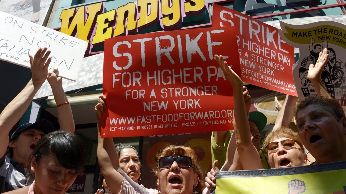 People gathered outside a Wendy's restaurant in New York City on Monday as part of a one-day strike calling for higher wages for fast-food workers.